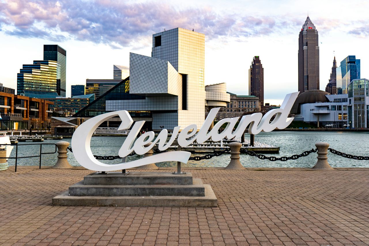 Cleveland script sign at North Coast Harbor with the Rock & Roll Hall of Fame and downtown skyline