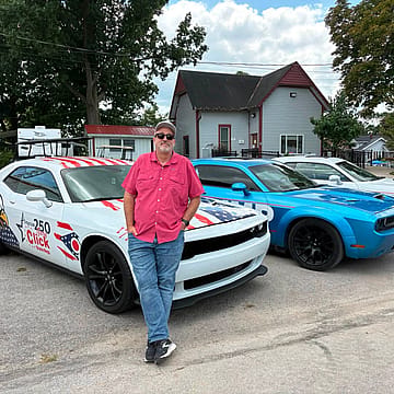Gary Click is showing off a campaign-wrapped Challenger after racking up 10 traffic citations