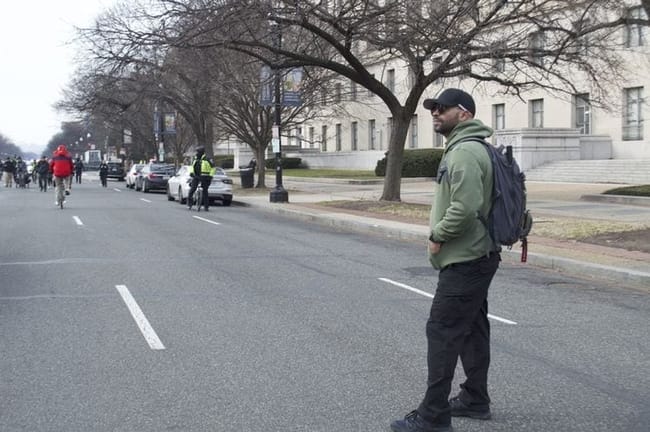 Former national Proud Boys leader Enrique Tarrio looked on as far-right activists celebrating the Jan. 6 Capitol attack marched down Constitution Avenue on Tuesday, Jan. 6, 2026. Tarrio was sentenced to 22 years in prison on sedition charges related to the attack, but President Donald Trump commuted his sentence. (Photo by Ashley Murray/States Newsroom)
