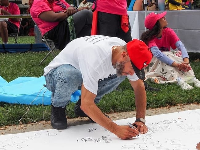Pablo Andraes-Ranos, 44, of Hartford, Connecticut, who attended the Next250 march with Formerly Incarcerated, Convicted People & Families Movement, signed the rally’s “Declaration of Interdependence” in Washington, D.C., on Saturday, June 27, 2026. (Photo by Ashley Murray/States Newsroom)