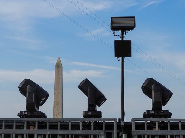 Lights from the Ultimate Fighting Championship structure on the White House South Lawn frame the Washington Monument on Thursday, June 11, 2026. (Photo by Ashley Murray/States Newsroom)