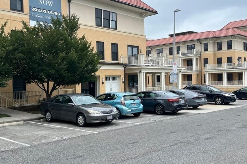 Cars in a parking lot at an apartment complex in Washington, D.C. In recent years, housing shortages have prompted more cities and states to scale back or even eliminate minimum parking requirements. (Photo by Scott S. Greenberger/Stateline)