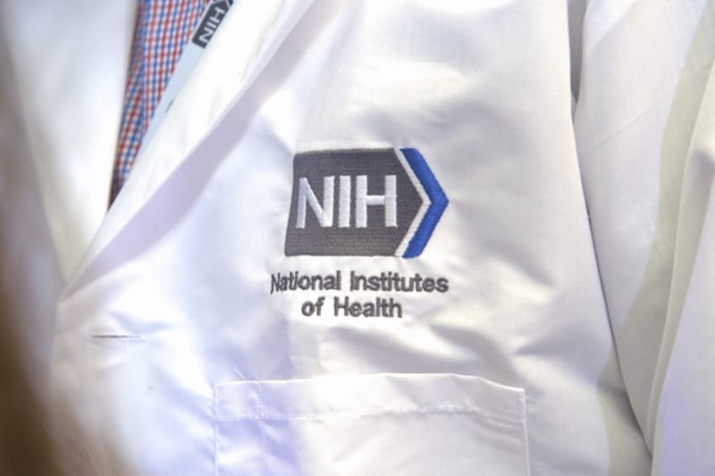 Democrats in Congress are raising questions about a draft rule proposed by the Trump administration that would change the way grants, such as those by the National Institutes of Health, are administered. Shown is an NIH Pediatric Oncology Branch researcher's lab jacket, embroidered with the NIH logo. (Photo courtesy NIH)