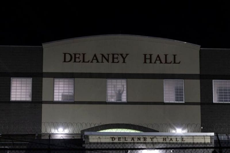 A detainee stands silhouetted in a window of the Delaney Hall detention center in Newark, N.J., on May 28, 2026. Many federal judges are freeing immigrants held under a mandatory detention policy. (Photo by Anne-Marie Caruso/New Jersey Monitor)