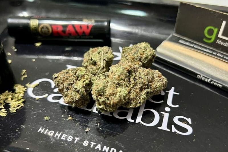 Cannabis flower rests on a rolling tray, surrounded by a pack of rolling papers, a grinder and a lighter. Lawmakers in a handful of states this year have introduced legislation to impose stricter THC limits on certain cannabis products. Photo by Amanda Watford/Stateline)