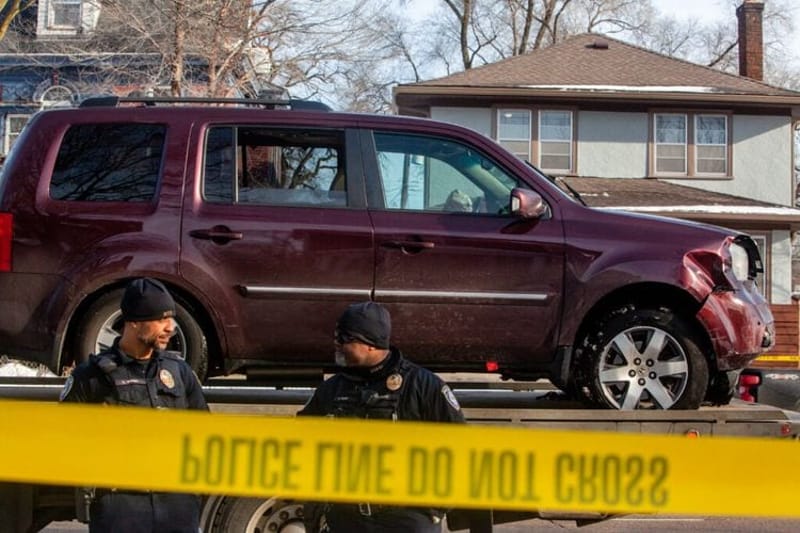 Local police officers stand guard as Renee Good's car is towed away after ICE officers shot and killed a woman through her car window Wednesday, Jan. 7, 2026 near Portland Avenue and 34th Street. (Photo by Nicole Neri/Minnesota Reformer)