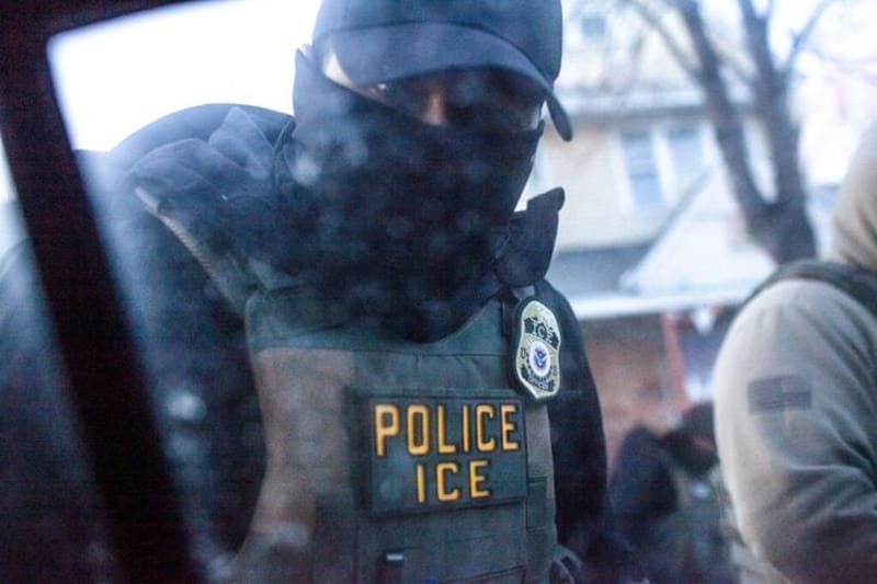 A masked U.S. Immigration and Customs Enforcement agent knocks on a car window in Minnesota on Jan. 12, 2026. (Photo by Nicole Neri/Minnesota Reformer)