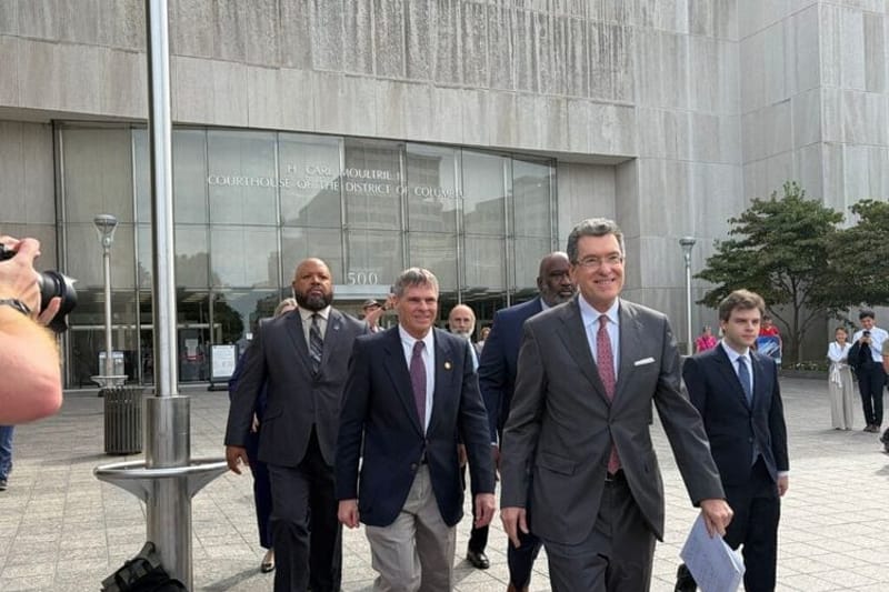 Olympian David Hearn, center left, walks out of District of Columbia Superior Court with his attorneys after a hearing on Sept. 4, 2026. (Photo by Ariana Figueora/States Newsroom)