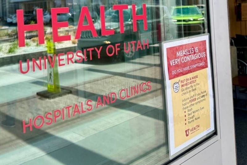 A University of Utah clinic in Salt Lake City displays a sign warning about measles last year. Utah is among the states that already has more measles cases in 2026 than in all of 2025, when cases reached the highest annual level since 1991. (Photo by McKenzie Romero/Utah News Dispatch)