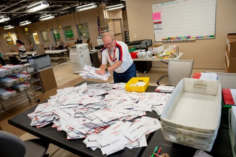 Election workers process ballots. (Photo by Spenser Heaps, States Newsroom.)