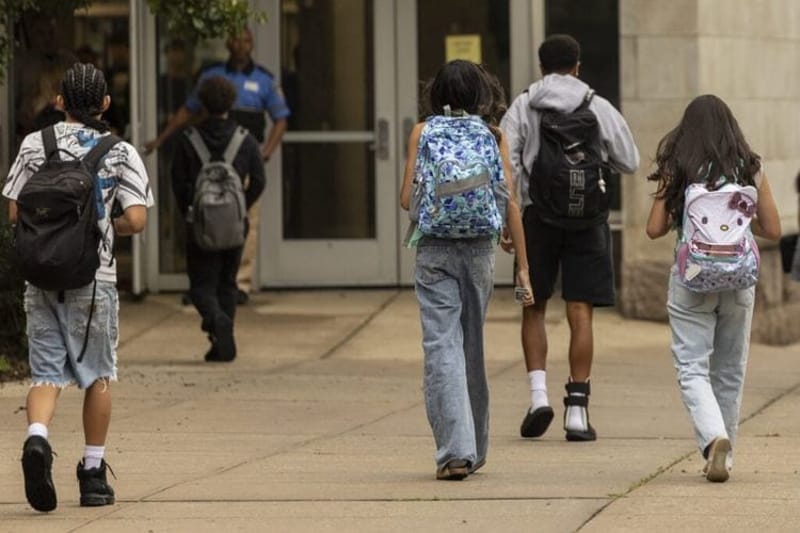 Students head into a high school on the first day of classes. (Photo by Anne-Marie Caruso, States Newsroom.)