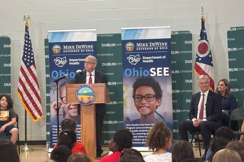 Ohio Gov. Mike DeWine talks about the OhioSEE program at a Dublin elementary school as Centers for Medicare & Medicaid Services Administrator Dr. Mehmet Oz looks on. (Photo by Megan Henry, Ohio Capital Journal).