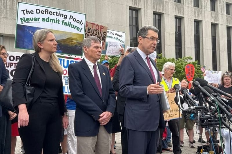 Norm Eisen, an attorney with the Democracy Defenders Fund, speaks outside District of Columbia Superior Court after an arraignment hearing for David C. Hearn, center, on felony charges of destruction of property of $1,000 or more. At left is Mary C. Dohrmann, senior counsel at the Washington Litigation Group and another member of Hearn’s legal team. (Photo by Jennifer Shutt/States Newsroom)