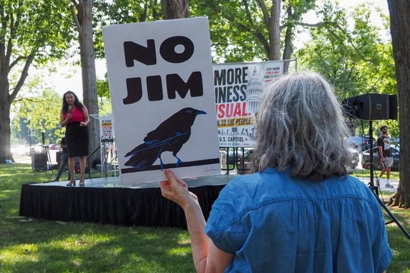 A protester listened to U.S. Rep. Analilia Mejia, D-N.J., at a rally on Capitol Hill on Wednesday, May 20, 2026, as the representative spoke against the recent U.S. Supreme Court decision to strike down part of the Voting Rights Act. (Photo by Ashley Murray/States Newsroom)