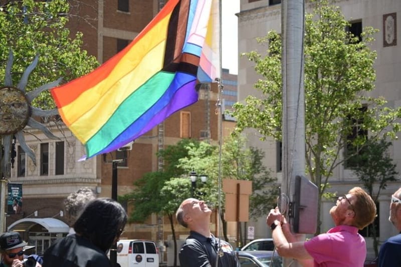 City officials from Lansing, Mich., raise a Pride flag over the Lansing City Council at the beginning of this month. Some Republican governors are relabeling June, widely recognized as Pride Month, with conservative-friendly monikers such as “Nuclear Family Month.” (Photo by Katherine Dailey/Michigan Advance)