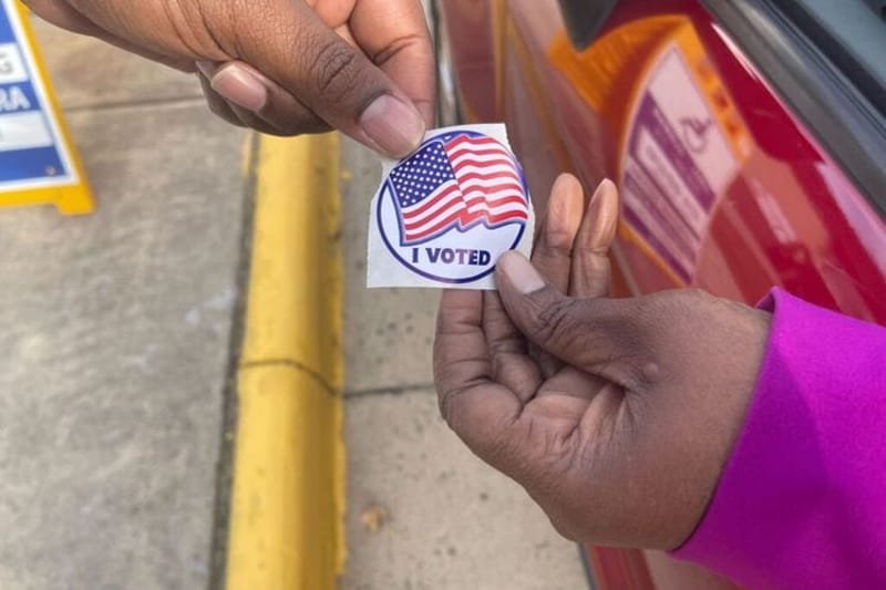 A Fairfax County, Virginia, voter receives a sticker on Election Day, Nov. 4, 2025. (Photo by Nathaniel Cline/Virginia Mercury)