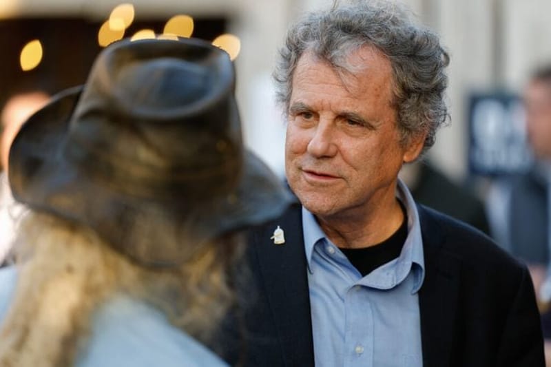 U.S. Senator Sherrod Brown speaks to a supporter at a Democratic Party campaign event for Franklin County voters. (Photo by Graham Stokes for Ohio Capital Journal. Republish photo only with original article.)