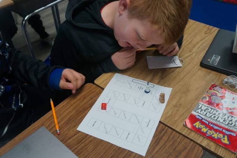A student reads at his desk in Oregon. The state and at least five others enacted laws this year aiming to reduce chronic absenteeism. (Photo by Alex Baumhardt/Oregon Capital Chronicle)