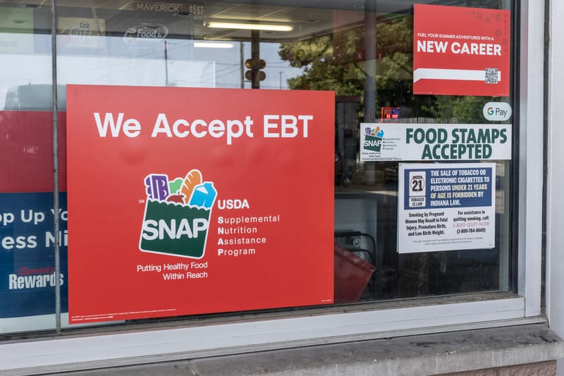 A sign noting the acceptance of electronic benefit transfer cards for food aid is displayed at a store. (Photo: iStock)
