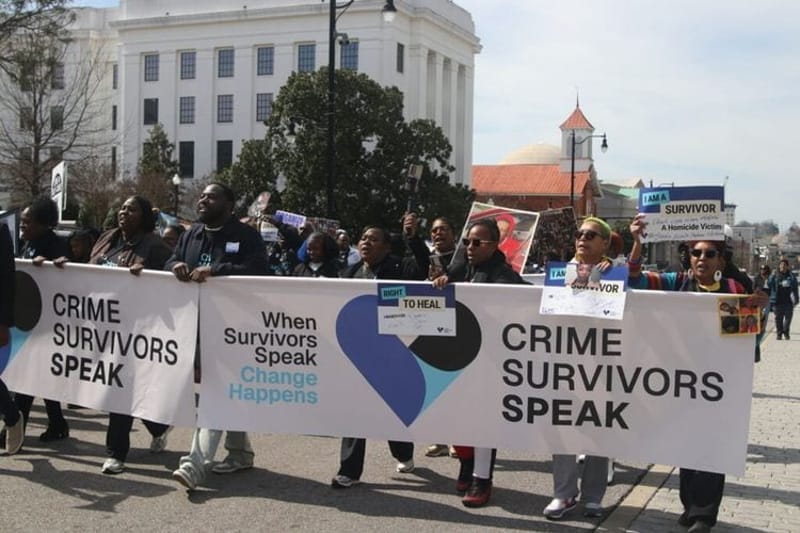 Survivors and loved ones of violent crime march toward the Alabama Capitol building in February to urge lawmakers for more robust support and services for people who have endured incidents of violent crime. Several states, including Alabama, have considered legislation this year that would support victims of crimes in various ways. (Photo by Ralph Chapoco/Alabama Reflector)