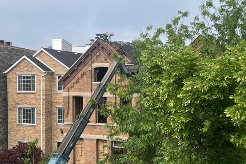 A construction worker balances atop a roof. States and cities are loosening building code requirements in an effort to lower construction costs and boost affordable housing. (Photo by Robbie Sequeira/Stateline)