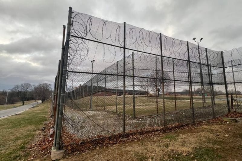 Barbed wire and fences surround the Charles H. Hickey Jr. School, a juvenile detention center in Maryland. The state’s recent changes to its juvenile justice laws aim to reduce the number of young people entering the adult criminal justice system while expanding rehabilitative services. (Photo by Amanda Watford/Stateline)
