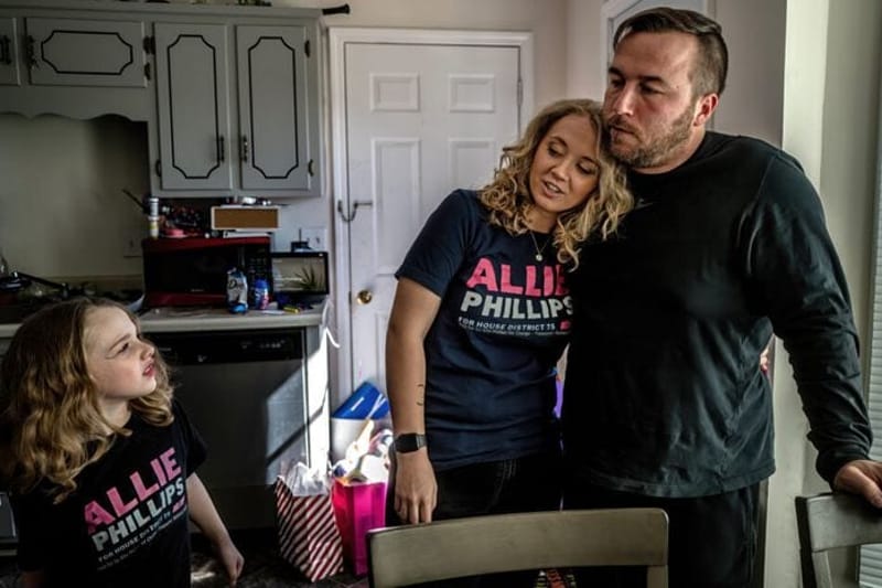 Allie Phillips, one of the plaintiffs suing the state of Tennessee over its abortion bans, stands in her kitchen with her husband and daughter in February 2024. Phillips unsuccessfully ran for a legislative seat in 2024, in part based on her story of having to leave the state for a medically necessary abortion, and is running again this year. (Photo by John Partipilo for the Tennessee Lookout)