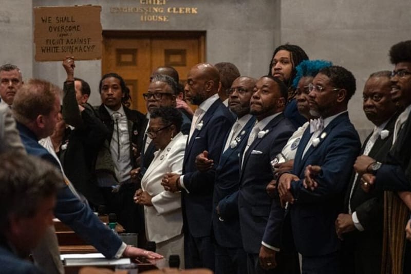 Tennessee Democrats lock arms on the Tennessee House floor in protest of a Republican redistricting vote that split up a majority-Black, majority-Democratic congressional district. Tennessee is one of several states redrawing its congressional maps in the aftermath of a recent US Supreme Court decision. (Photo by John Partipilo/Tennessee Lookout)