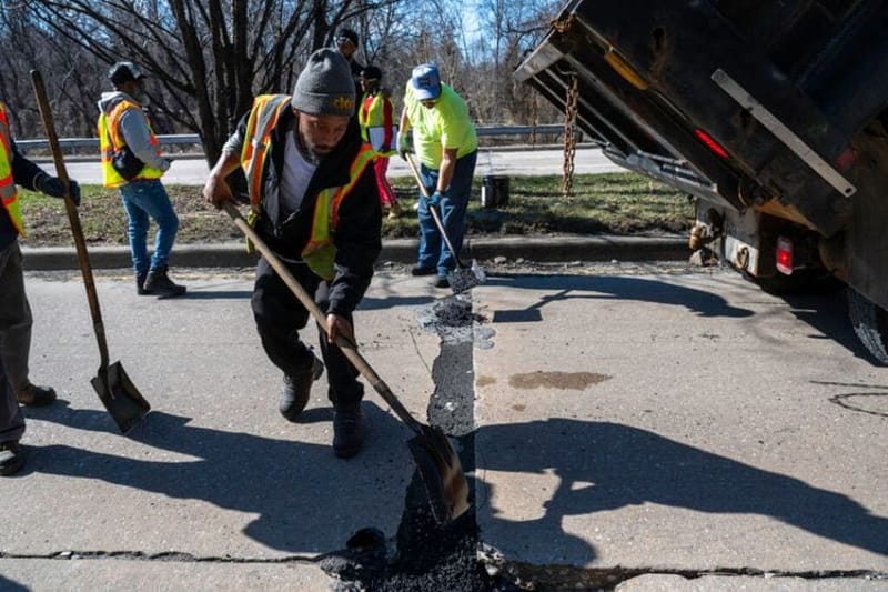 A work crew fills potholes on Perring Parkway in Baltimore. Crews filled at least 32,000 potholes from late February through mid-March, and the city aims to fill another 25,000 potholes by mid-July. (Photo by J.J. McQueen/Baltimore City Mayor’s Office)