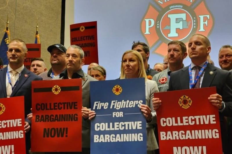 Members of Virginia Professional Firefighters association hold signs during their biannual convention in May to protest Democratic Gov. Abigail Spanberger’s veto of collective bargaining legislation. New research found a significant spike in labor union membership, but growth is highly dependent upon state politics. (Photo by Charlotte Rene Woods/Virginia Mercury)