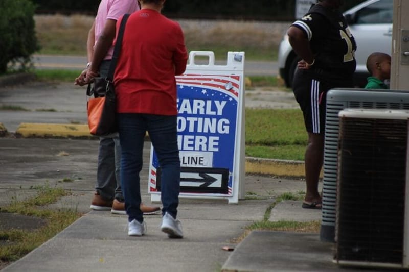 East Baton Rouge Parish, Louisiana, voters stand in line at an early voting location in 2022. Louisiana Gov. Jeff Landry has suspended Louisiana’s May 16, 2026, party primary elections for six U.S. House districts — after early voting had begun — following the U.S. Supreme Court’s decision to throw out the state’s existing congressional map. (Photo by Wes Muller/Louisiana Illuminator.)