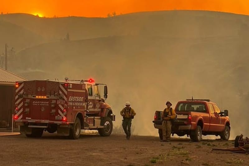 Firefighters work under an orange sky at the Rowe Creek Complex Fire in Oregon in late July. As fires spread rapidly across the Pacific Northwest this summer, wildfire veterans say extreme conditions and aggressive fire suppression could put crews in danger. (Photo by Brett Deedon/Oregon State Fire Marshal)