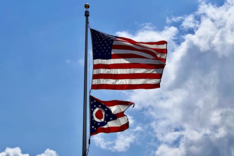 The Ohio burgee alongside the U.S. flag. (Photo by Hannah Wernecke on Unsplash)